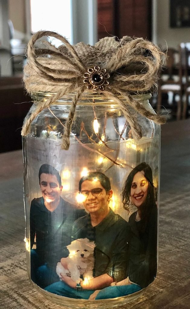 Personalized upcycled gift jar decorated with twine, a handwritten tag, and thoughtful handmade gifts.