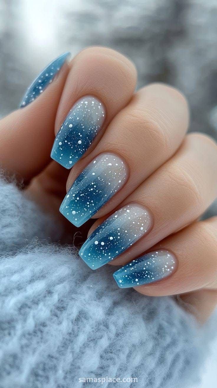 Icy blue Christmas nails with silver shimmer and delicate snowflake details.