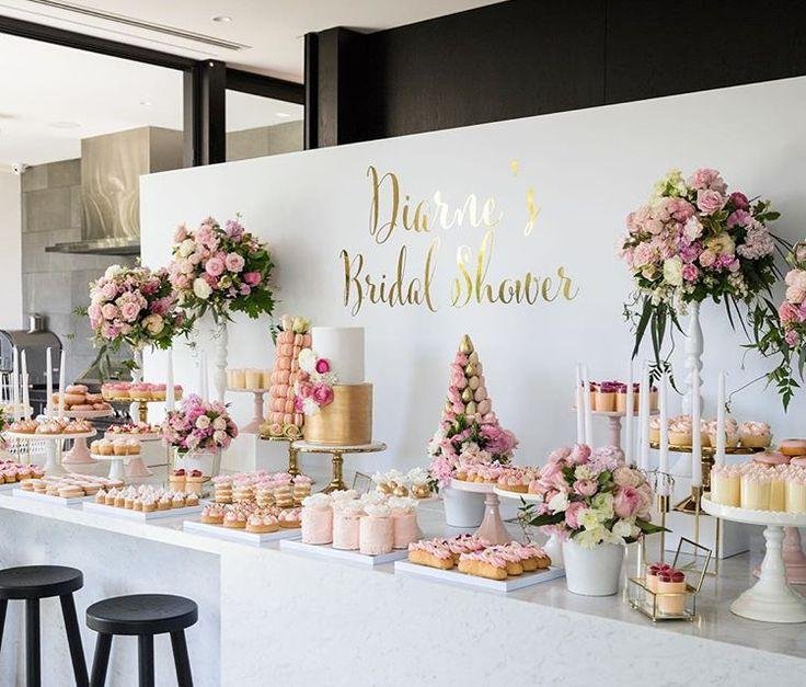 Romantic bridal shower featuring blush pink and white flowers, elegant desserts, delicate bows and soft decorative details.