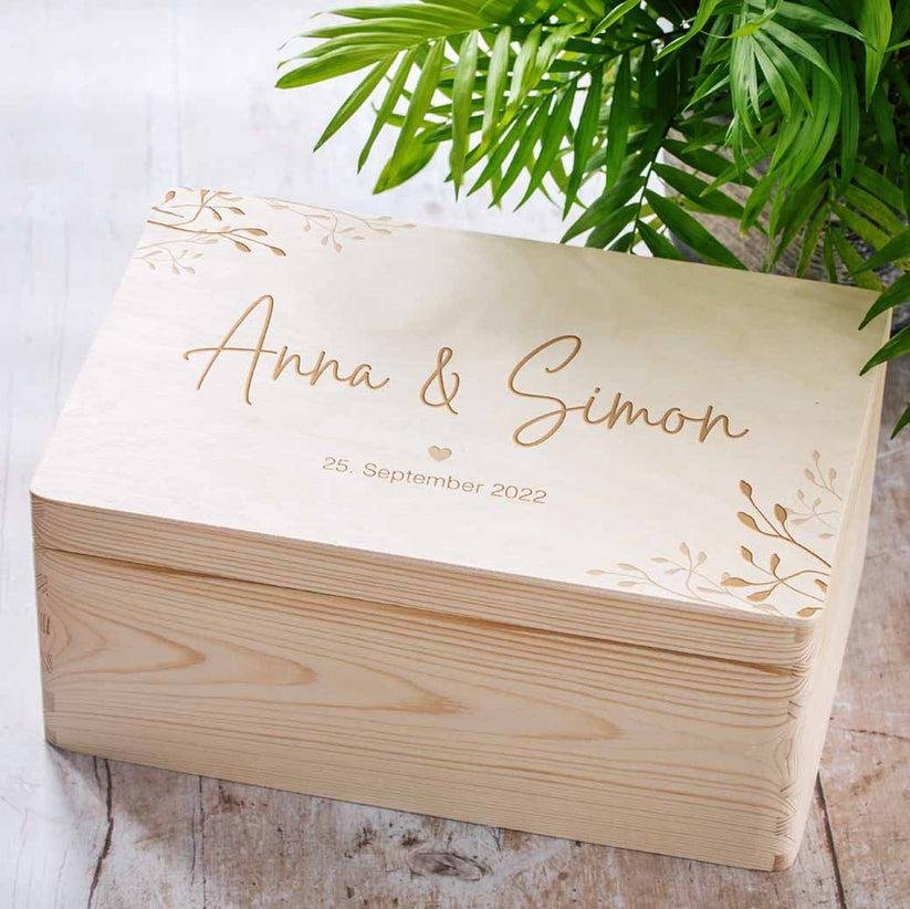 Personalized wedding keepsake box engraved with the couple's names.